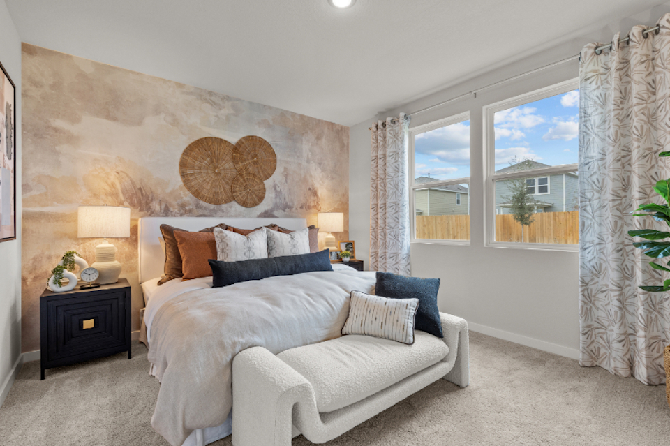 A bedroom with a large window.