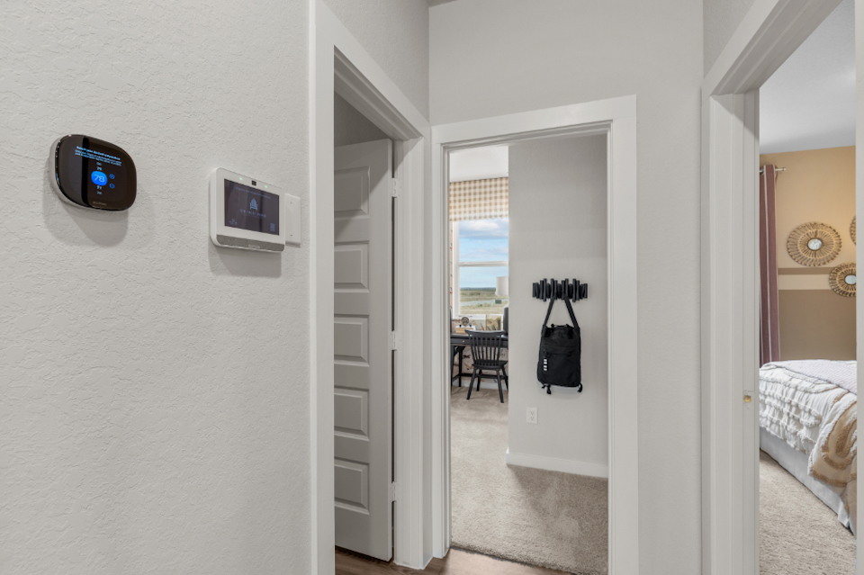 A room with a door and a bed.