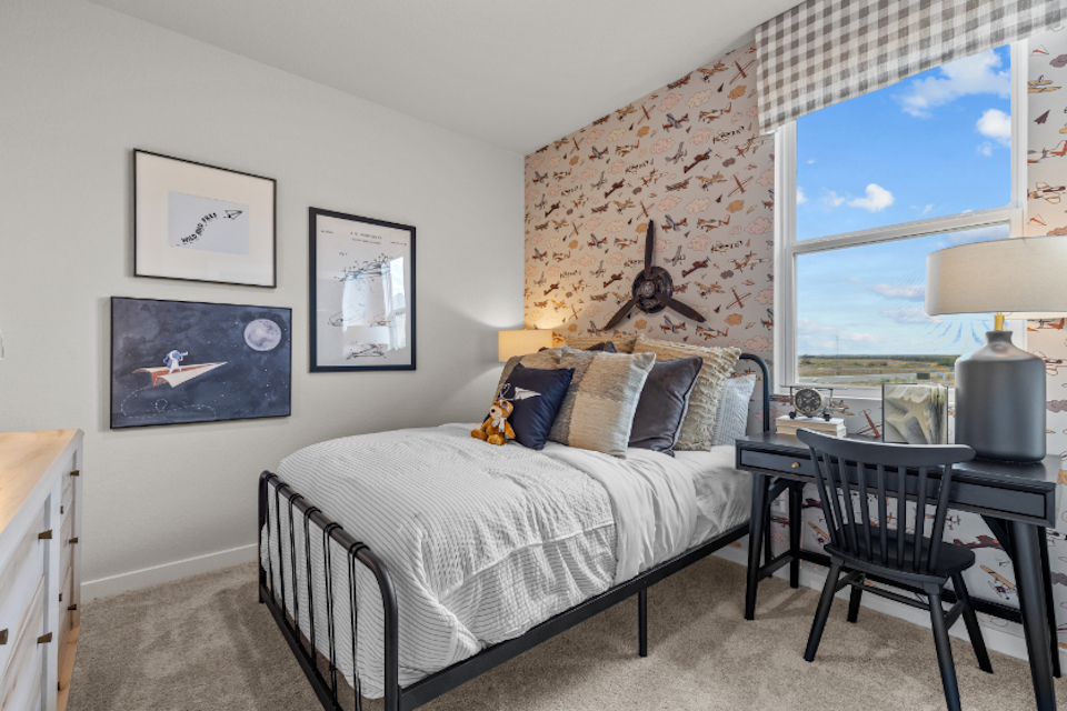 A bedroom with a bed and a table.