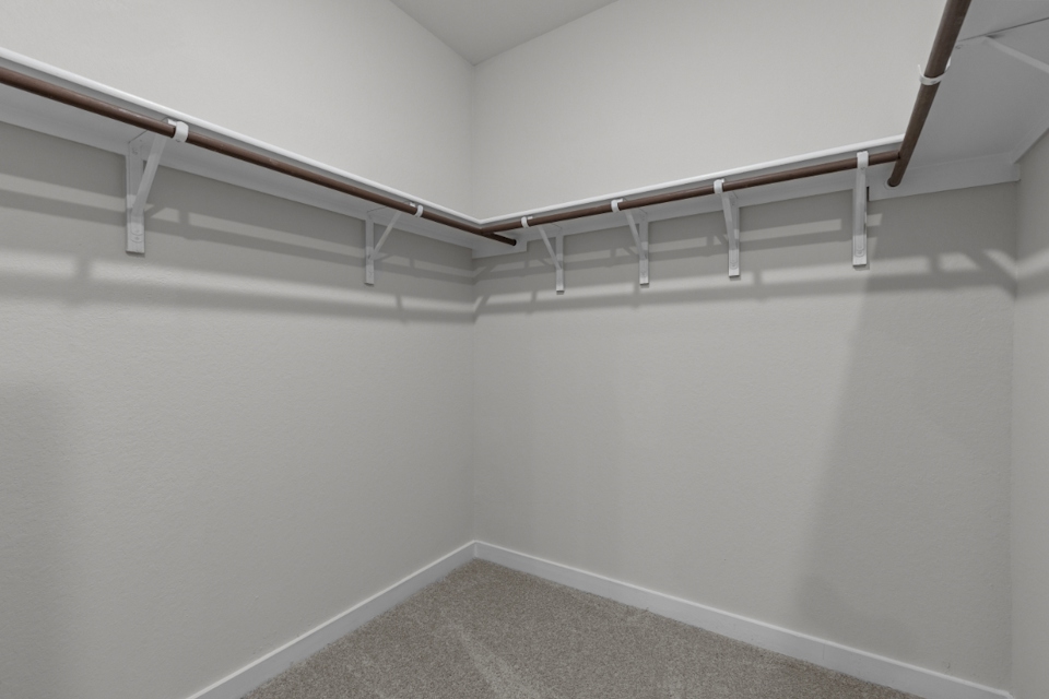 A white wall with a metal railing.