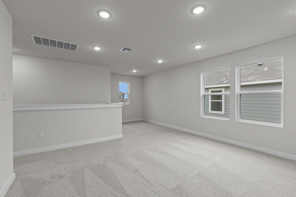 A room with white walls and windows.