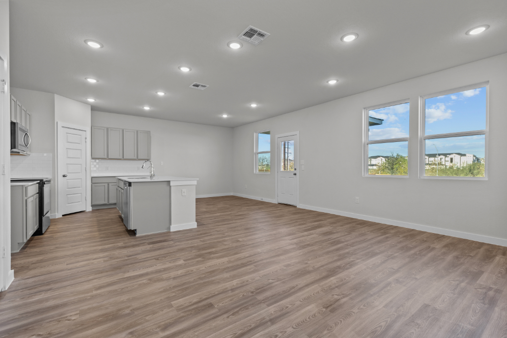 A kitchen with white cabinets.