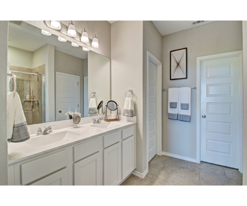 A bathroom with a large mirror.
