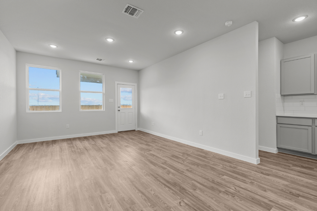 A room with a wood floor and white walls.