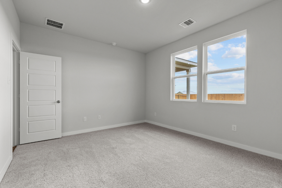 A room with white walls and a window.