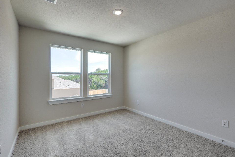 A room with a window and a carpet.