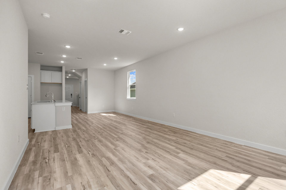 A room with a wood floor and white walls.