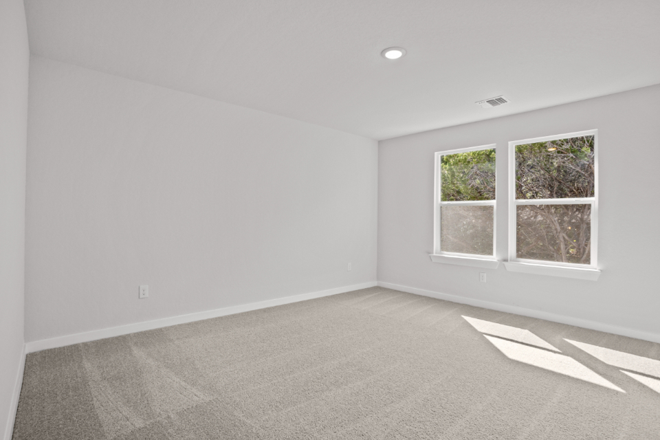 A room with a window and a rug in it.