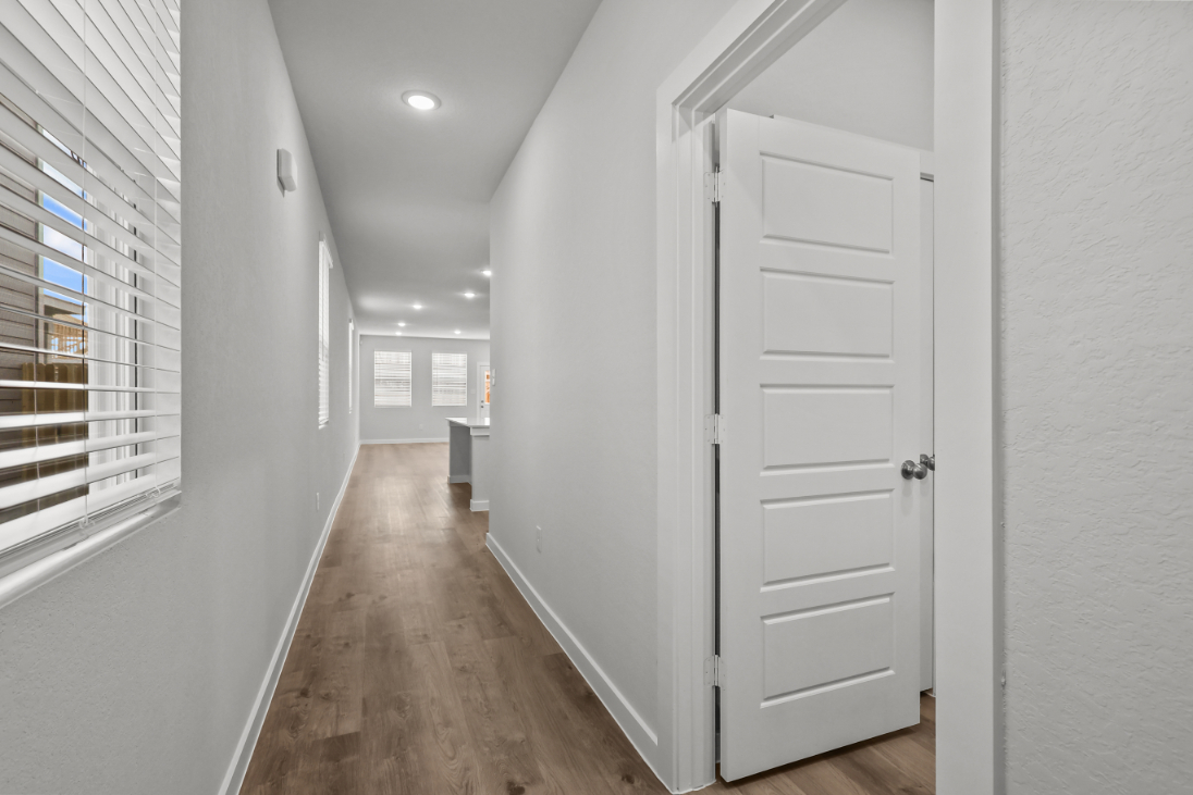 A hallway with white doors.