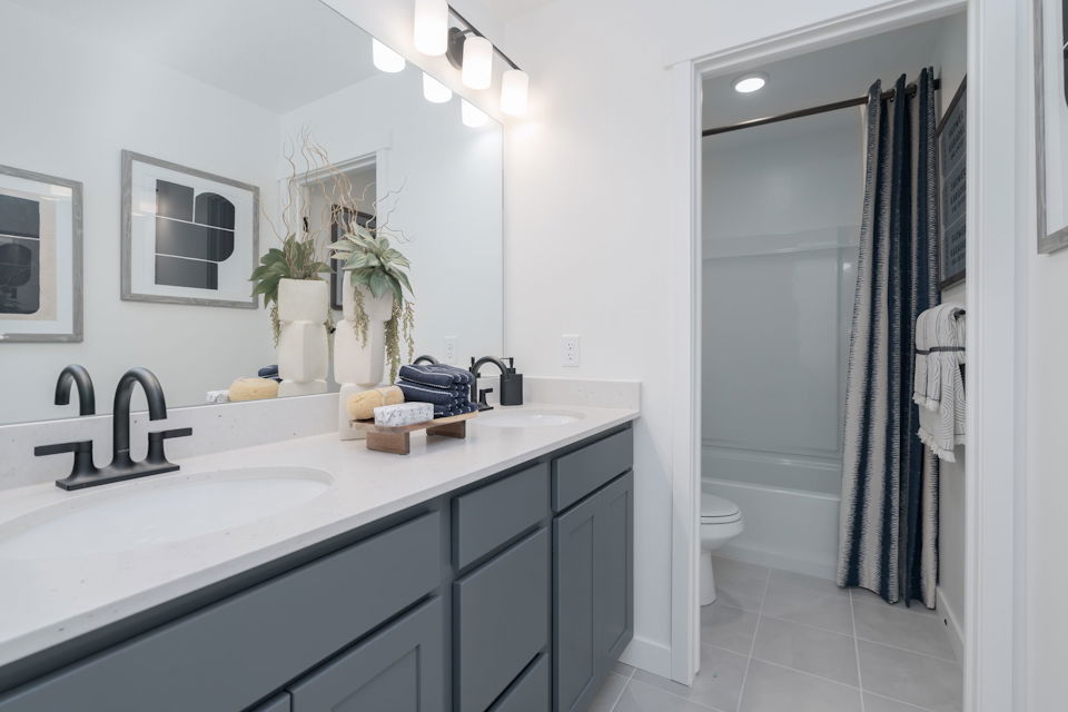 A bathroom with a sink and a shower.