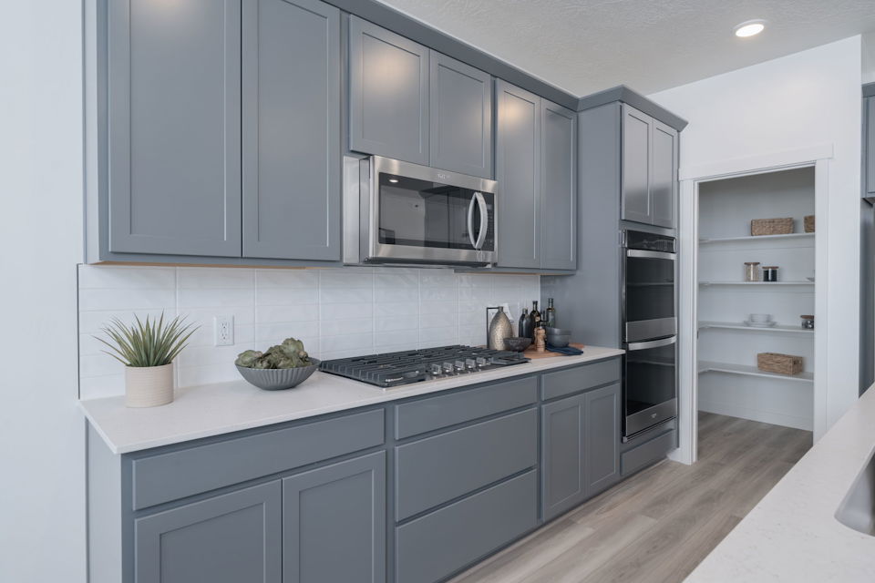 A kitchen with white cabinets.