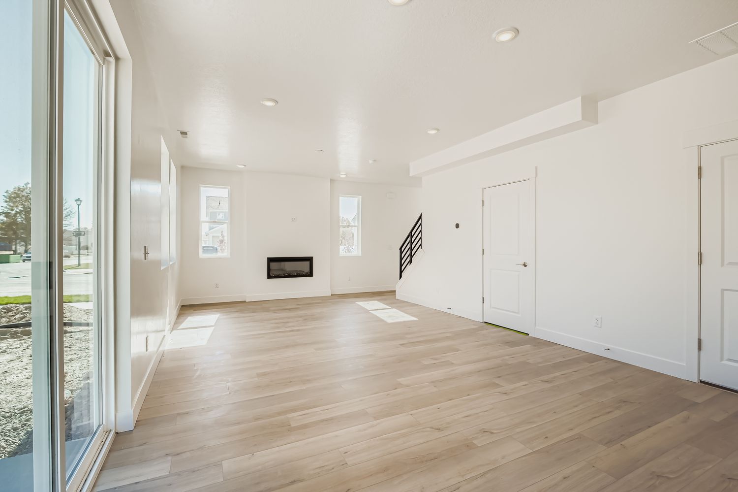 A room with a wood floor and white walls.