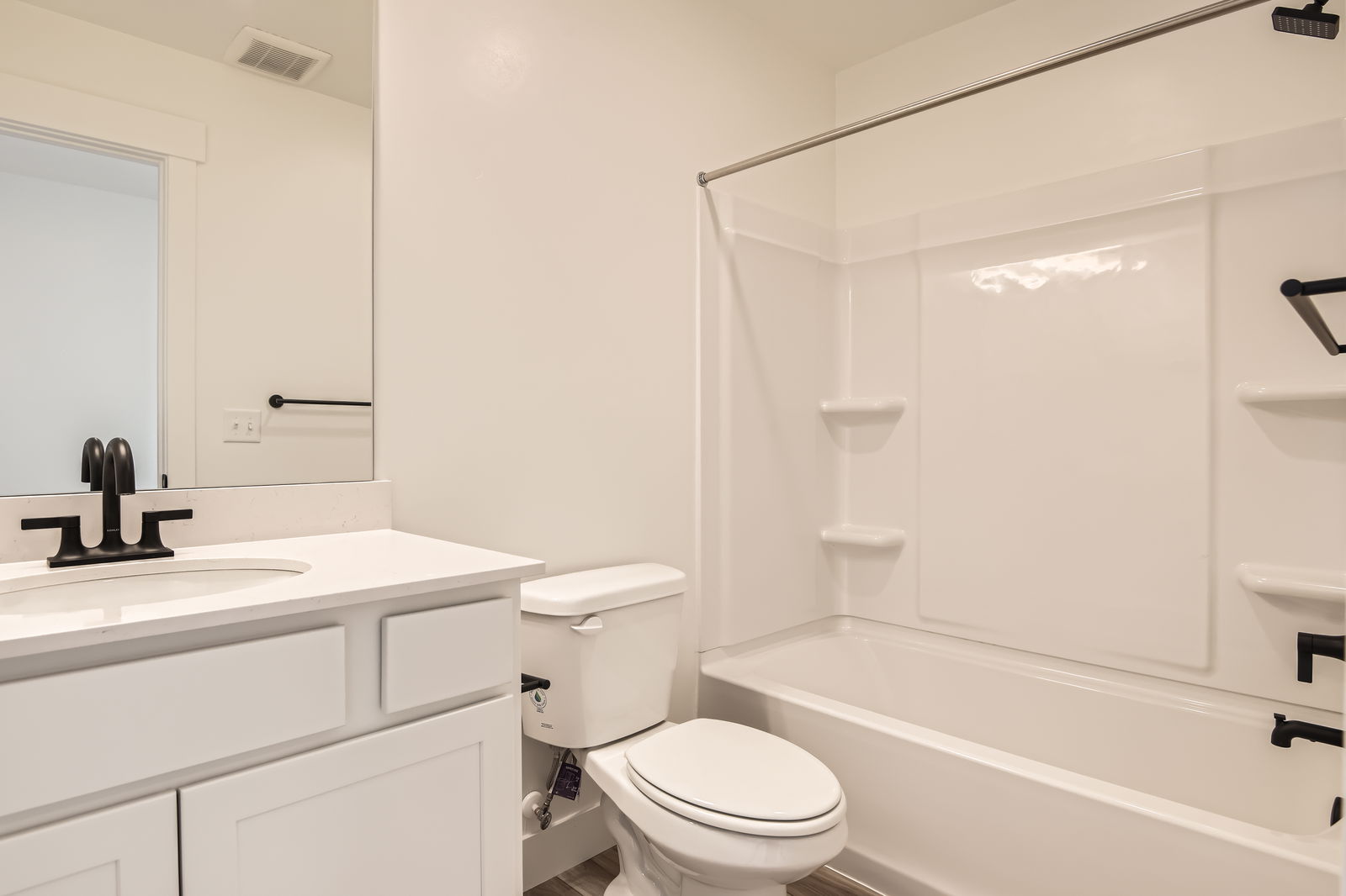 A bathroom with a tub toilet and sink.