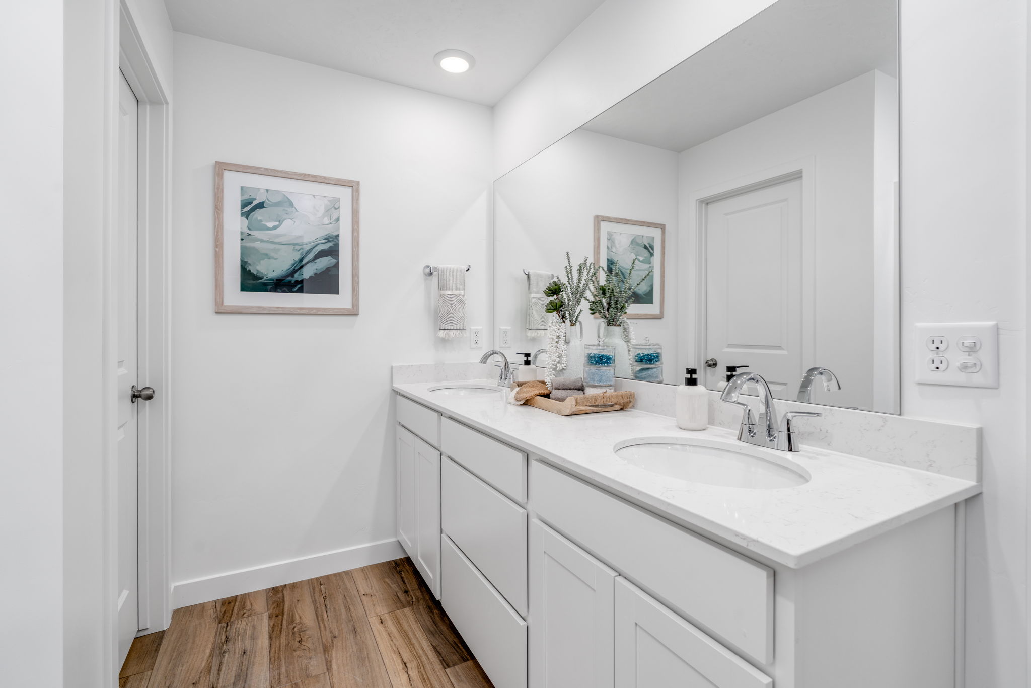 A bathroom with white cabinets.