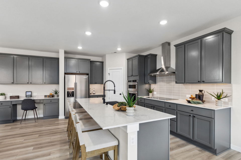 A kitchen with black cabinets.