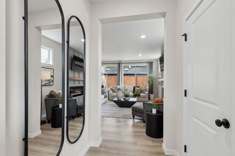 A room with a glass door and a couch and a table.