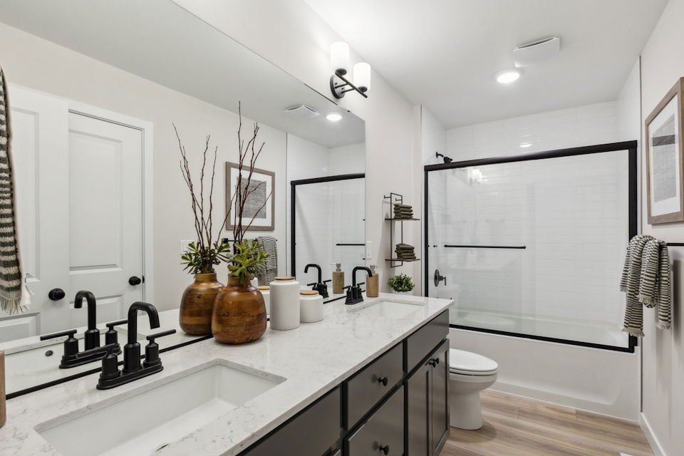 A bathroom with a tub sink and toilet.