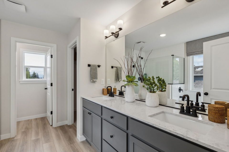 A bathroom with a large mirror.