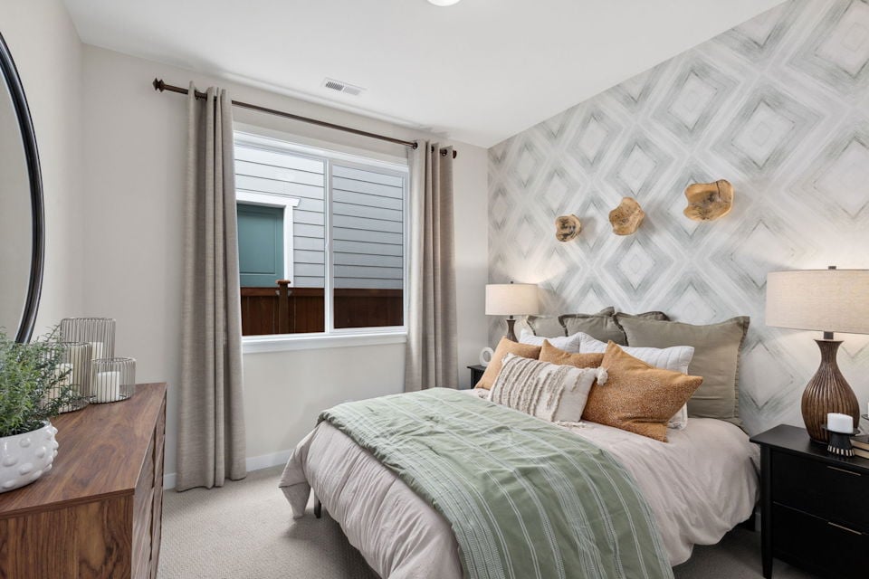 A bedroom with a bed and a window.