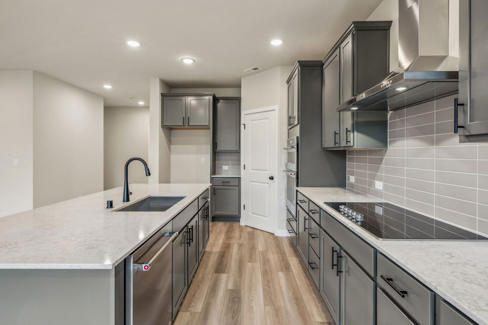 A kitchen with black cabinets.
