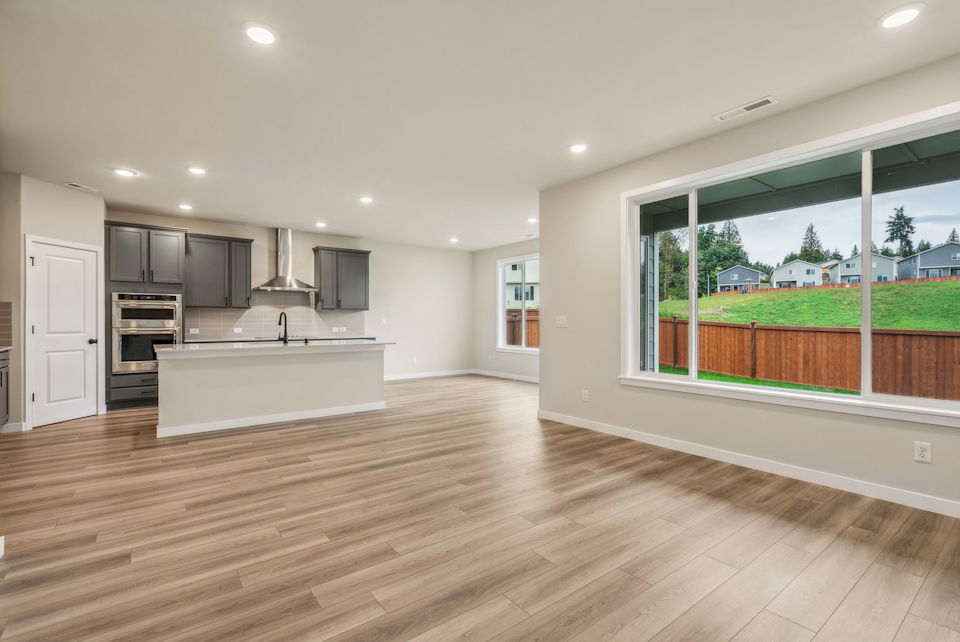 A kitchen with a large window.