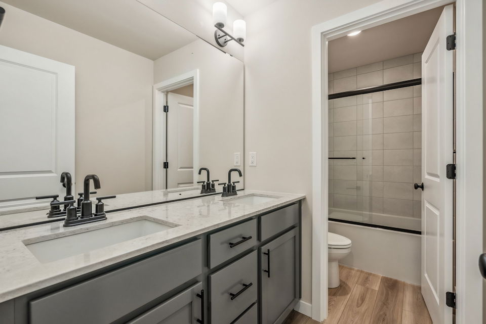 A bathroom with a sink and a shower.