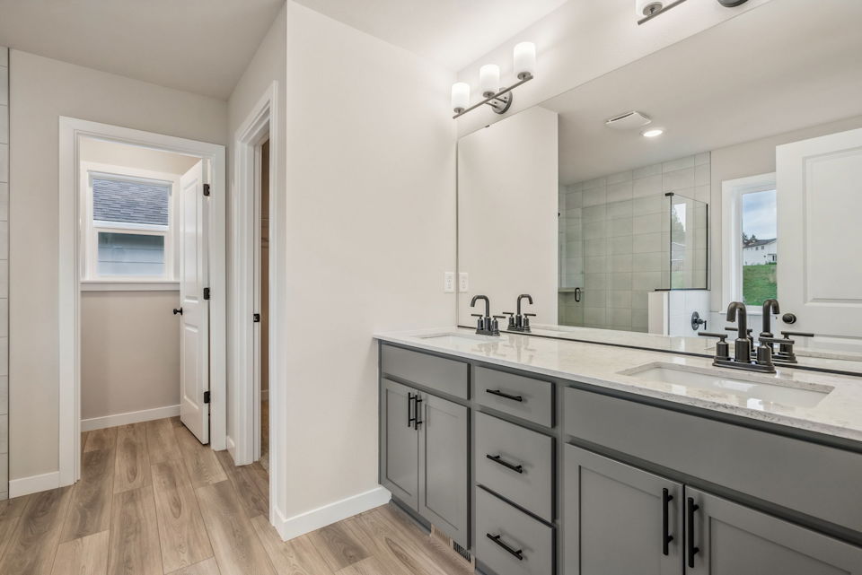 A bathroom with a large mirror.