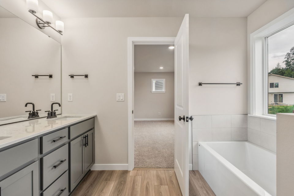A bathroom with a tub and sink.