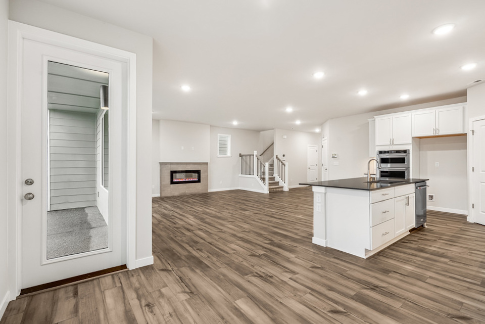 A kitchen with white cabinets.