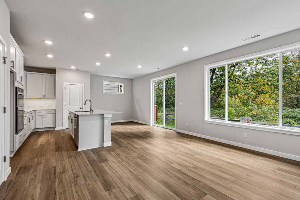 A kitchen with a wood floor.