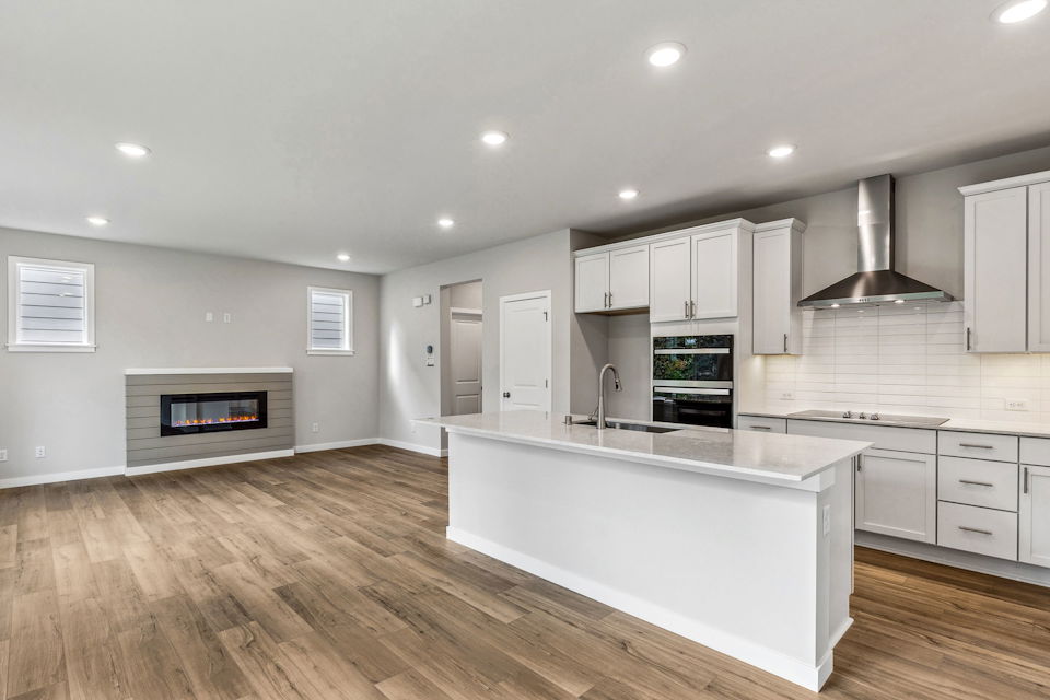 A kitchen with white cabinets.