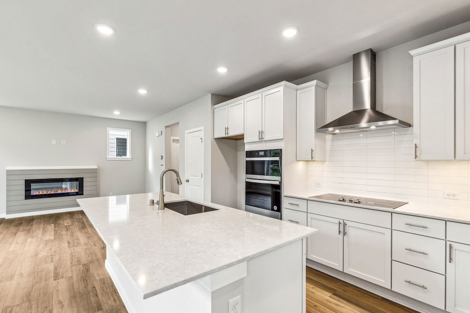 A kitchen with white cabinets.