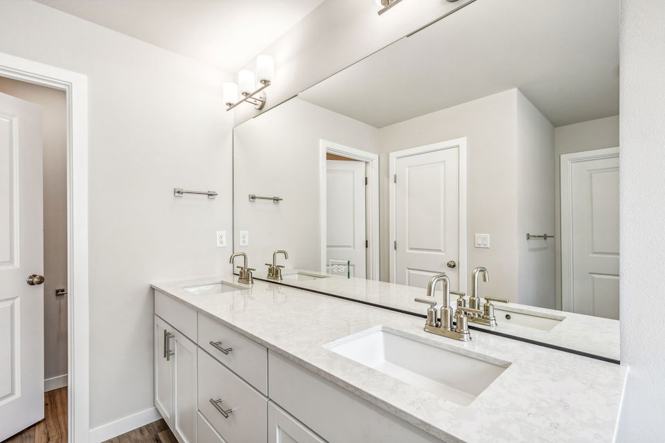 A bathroom with a large mirror.