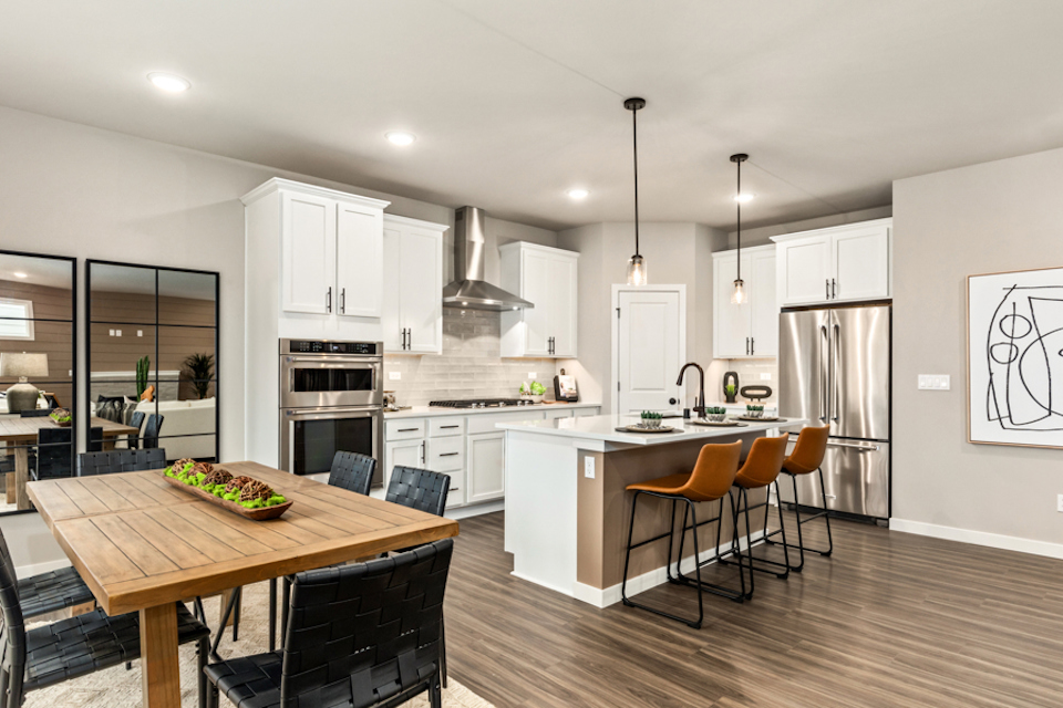 A kitchen with white cabinets.