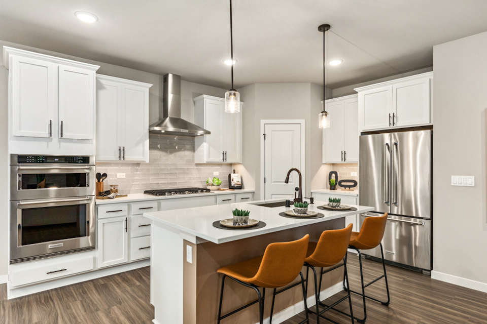 A kitchen with white cabinets.
