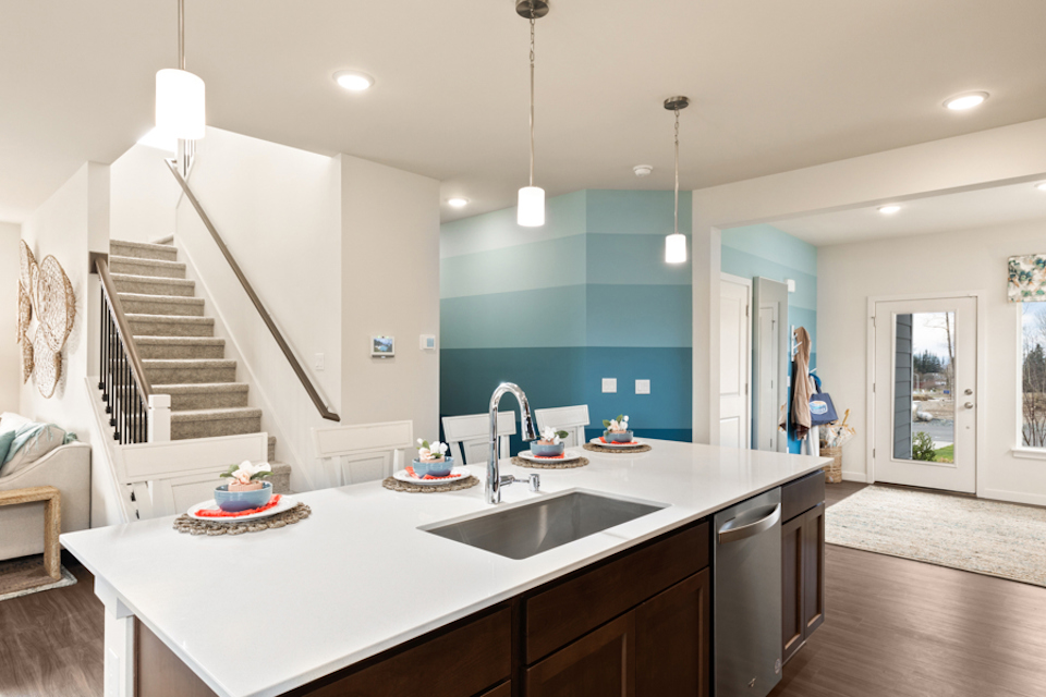 A kitchen with a large white counter.