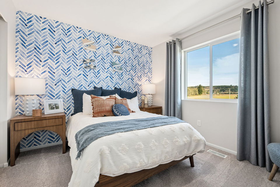 A bedroom with a blue wall.