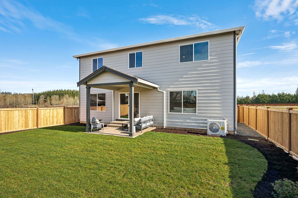 A house with a fence and grass.