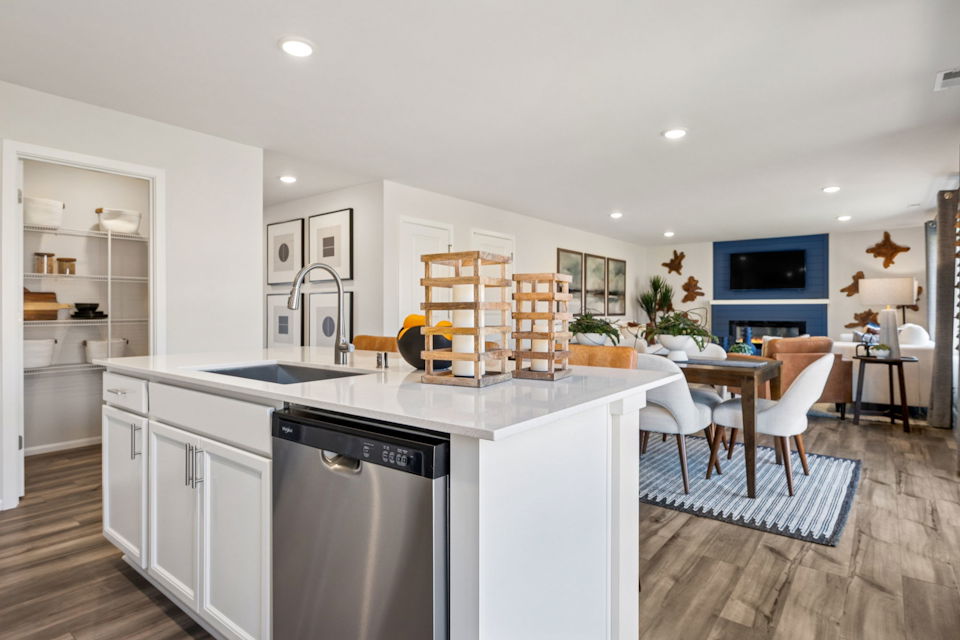 A kitchen with a table and chairs.