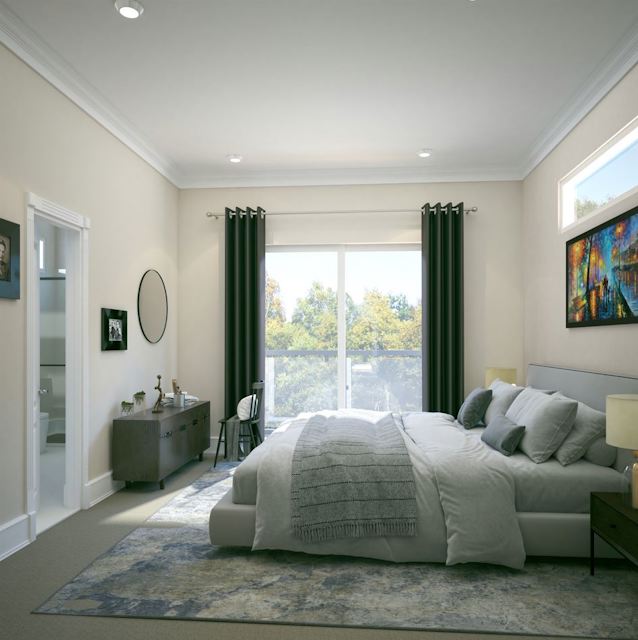 A bedroom with a large window.