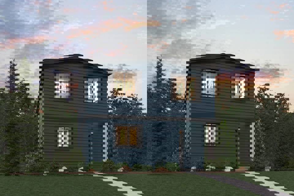 A blue house with trees in the back.
