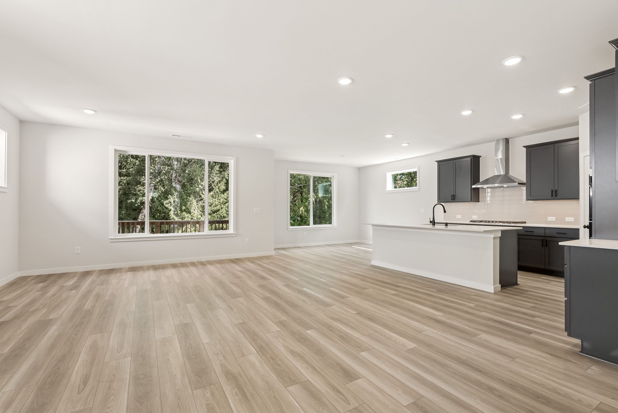 A large kitchen with a wood floor.