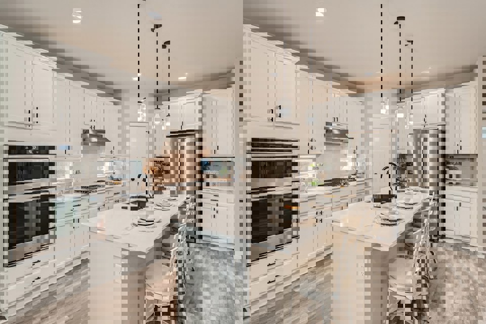 A kitchen with white cabinets.