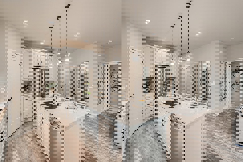 A kitchen with white cabinets.