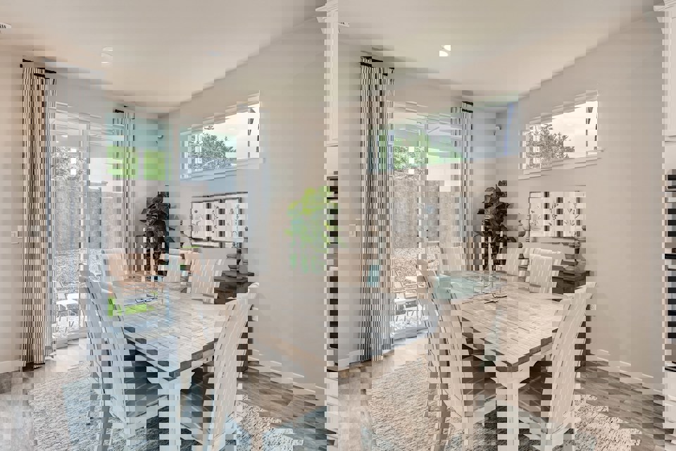 A dining room table with chairs.