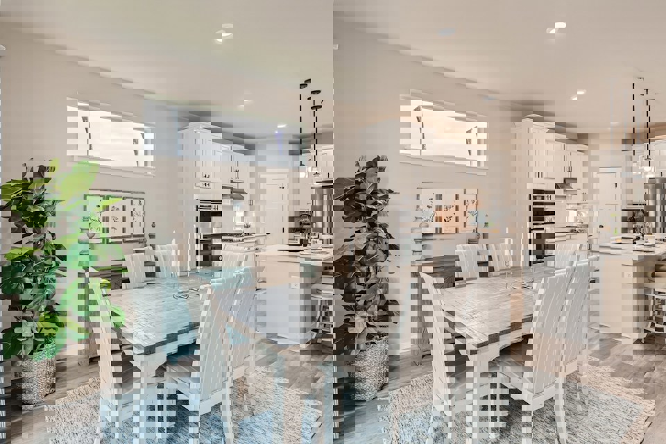 A dining room with a table and chairs.