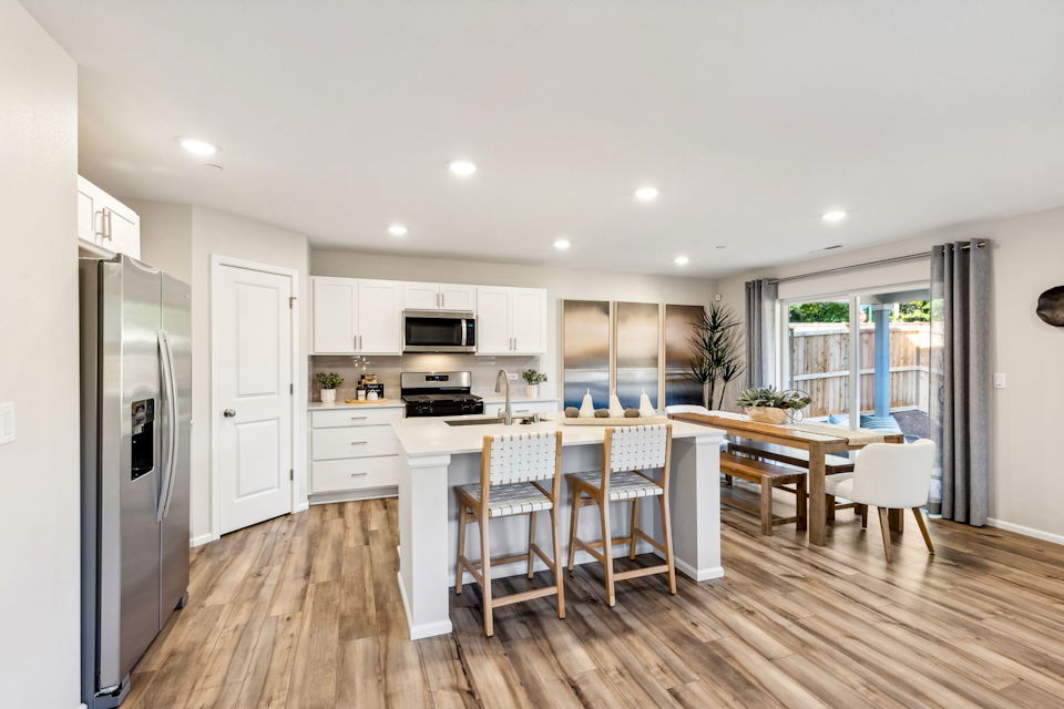 A kitchen with a wood floor.