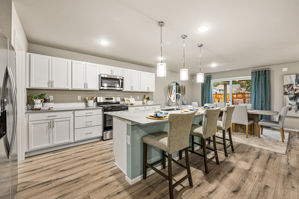 A kitchen with white cabinets.