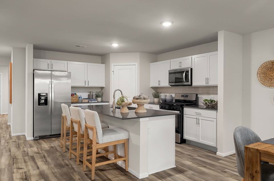 A kitchen with white cabinets.