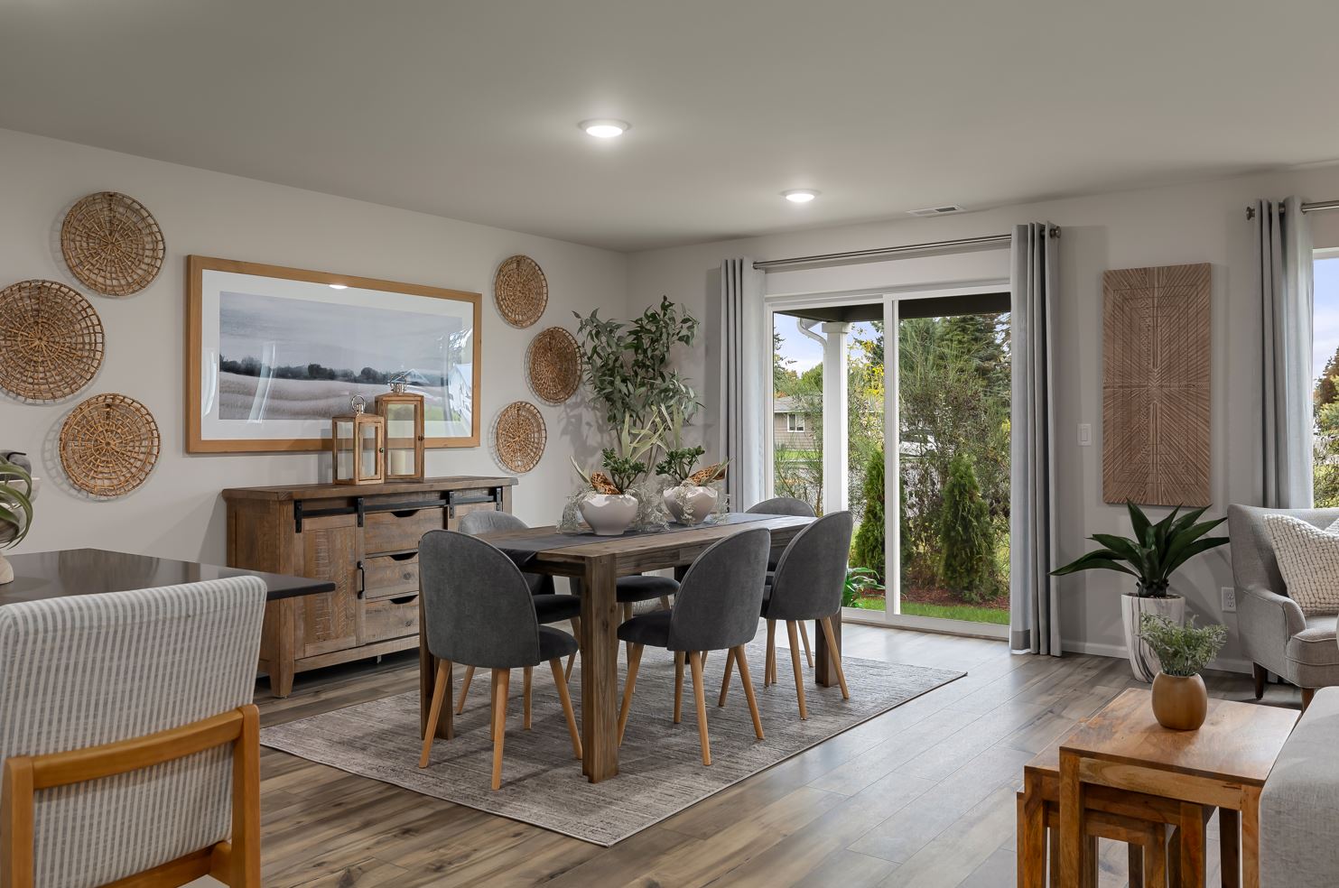 A room with a table chairs and a large window.